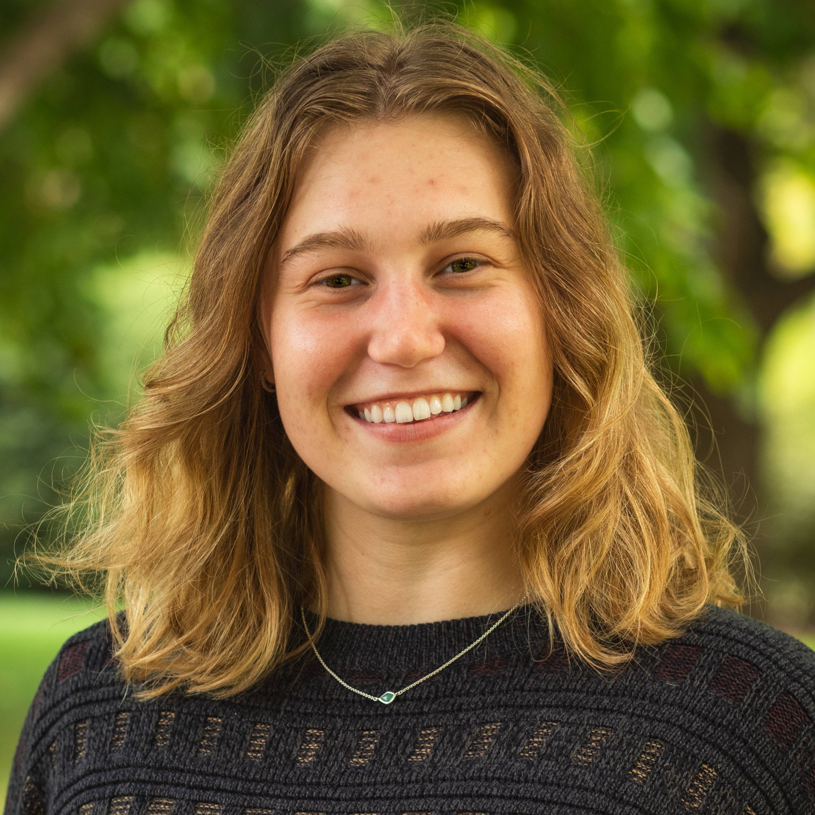 A headshot of Kristin Leutgeb wearing a black sweater outside
