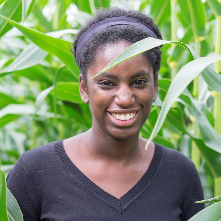 A headshot of Christine Sprunger smiling in a corn field 